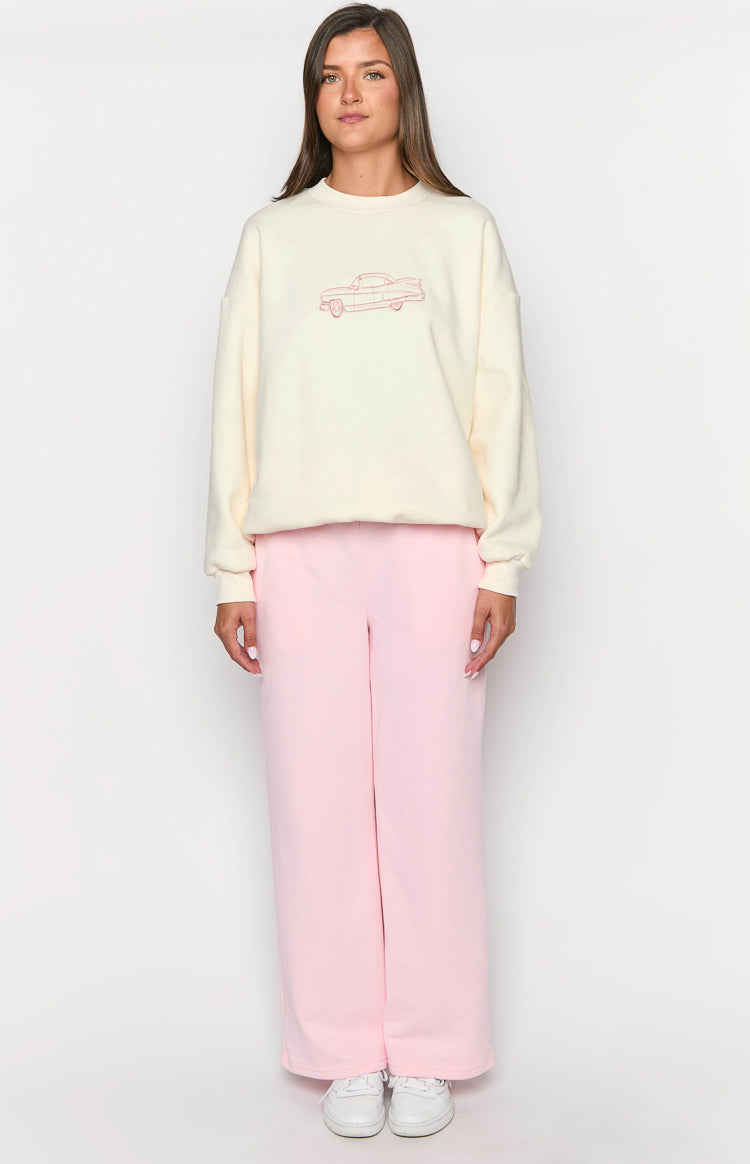 Front view of a cream crew neck sweater with a red outline car graphic and relaxed fit