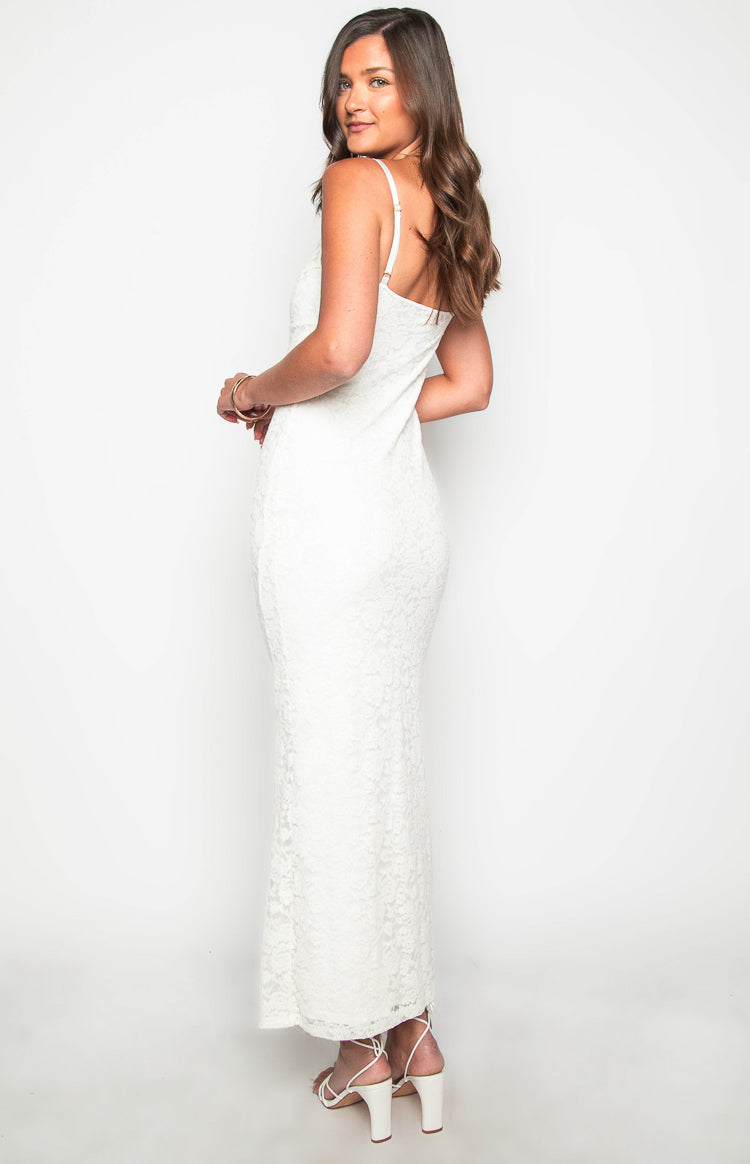Side-rear view of a white lace maxi dress with a fitted silhouette and thin spaghetti straps