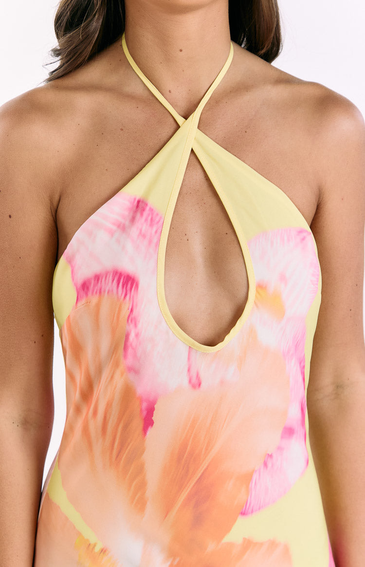 Close-up of the yellow halter neckline with a keyhole cutout and pink and orange hibiscus print