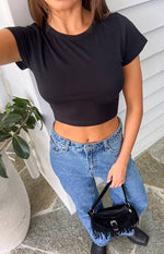Front view of a black fitted cropped baby tee with a crew neck and short cap sleeves