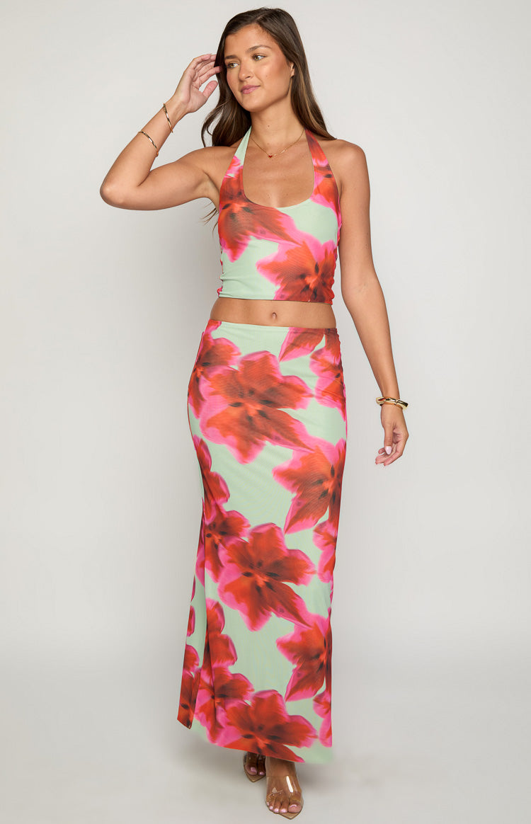 Front view of a light green bodycon maxi skirt with large red and pink abstract floral print
