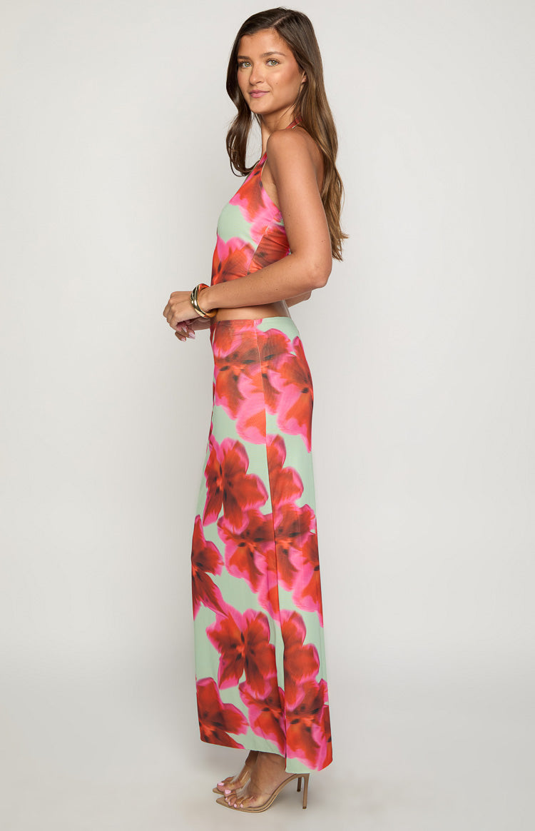 Side view of the high-waisted fitted green maxi skirt with large red and pink floral print