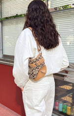 Rear view of the cream funnel neck sports jacket showing the relaxed fit and long sleeves with elasticated cuffs