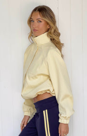 Cropped yellow funnel neck sports jacket with a relaxed fit, elasticated cuffs, and a cinched hem