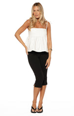 Front view of a white denim top with a square neckline, tie-up spaghetti straps, and a gathered peplum hem