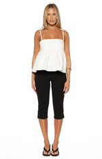 Front view of a white denim top with a square neckline, tie-up spaghetti straps, and a flared peplum hem