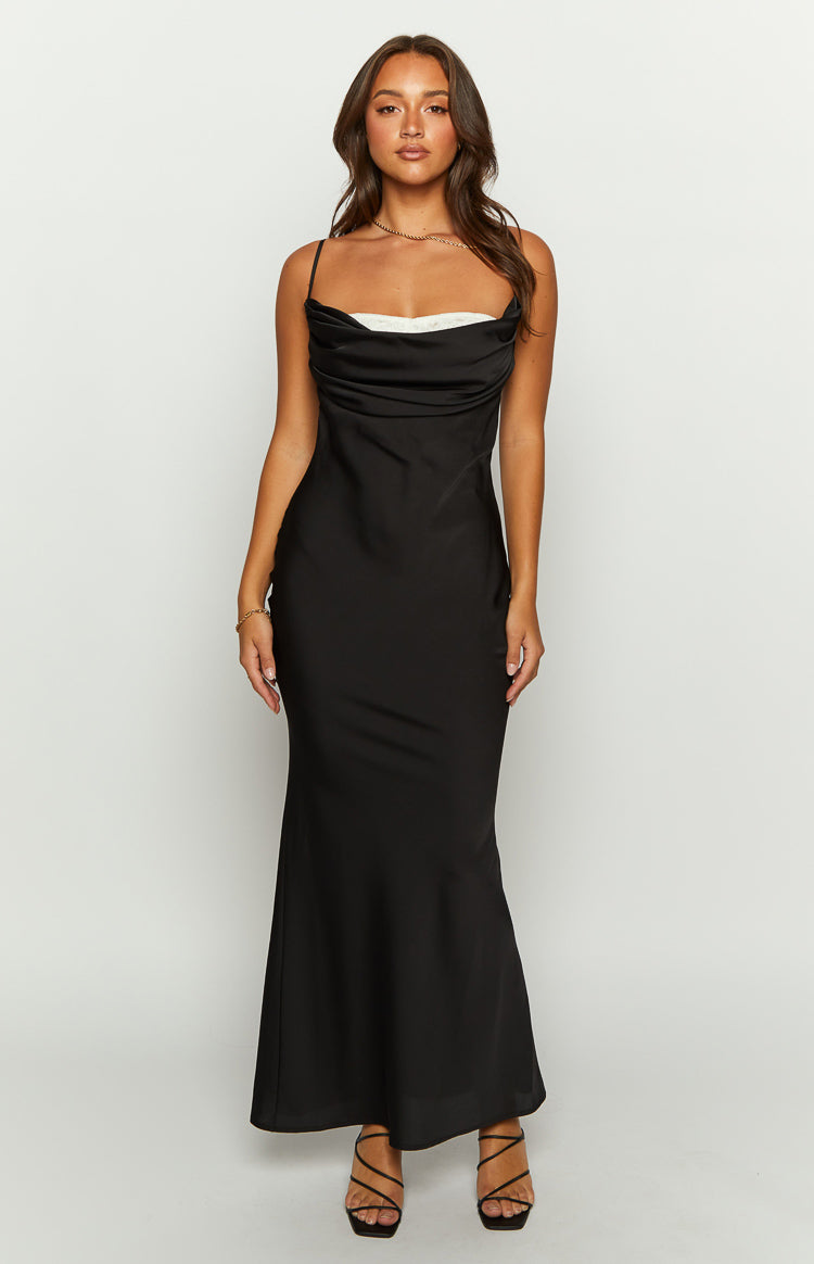 Front view of a black satin maxi dress with a draped cowl neckline, thin spaghetti straps, and a white lace trim