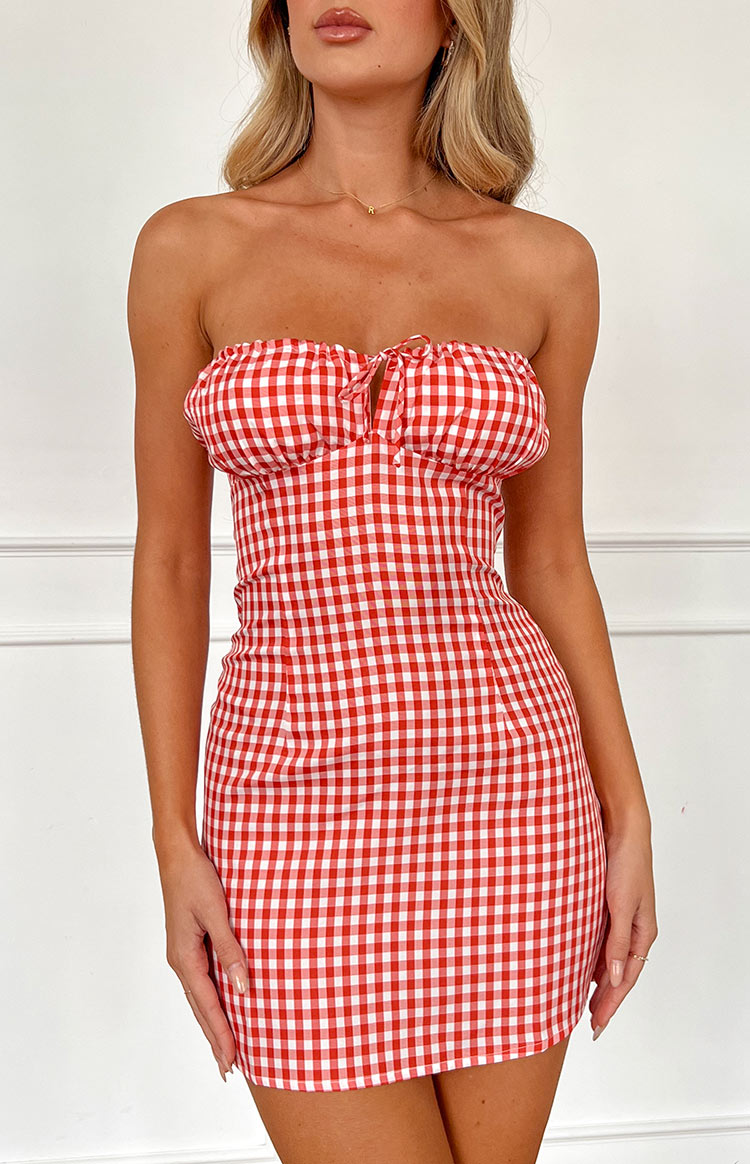 Close-up front view of the red and white gingham strapless mini dress with a ruched bust and tie detail