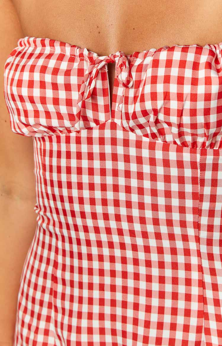 Close-up of the red and white gingham strapless mini dress showing the tie-front bust with a small keyhole