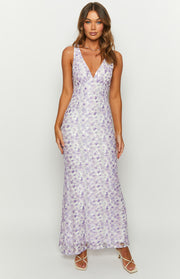 Front view of a purple floral lace maxi dress with a deep V-neck and sleeveless design, in a fitted silhouette