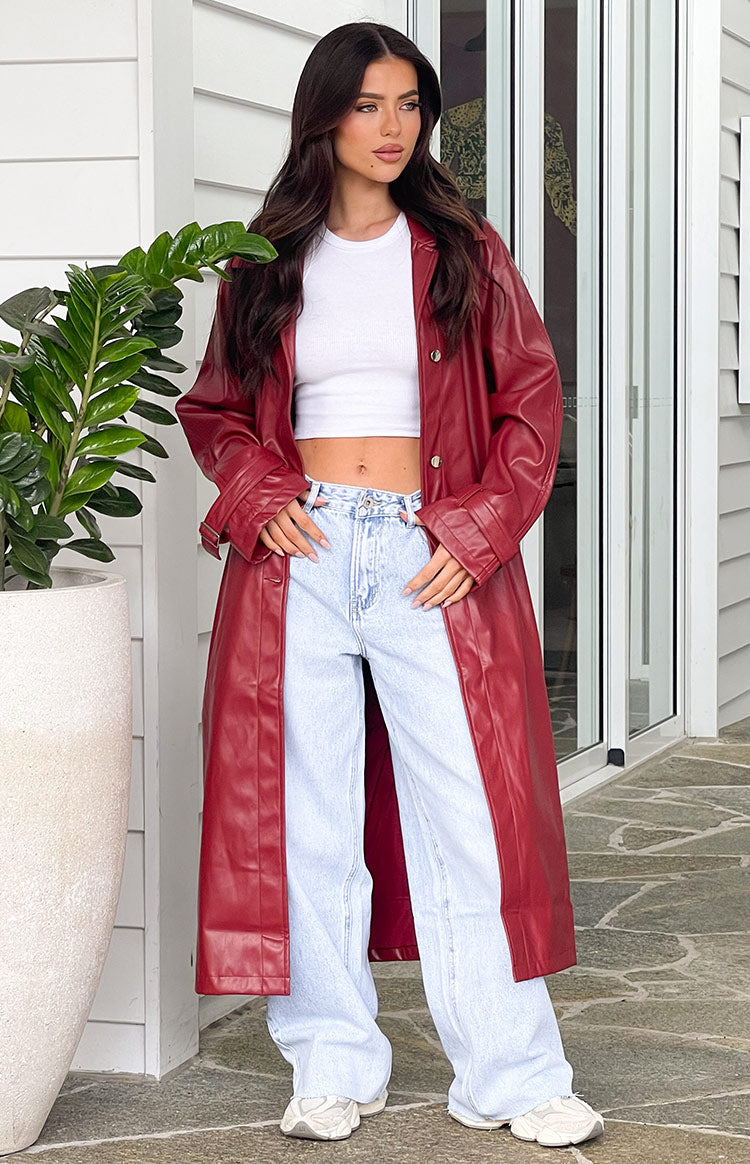 Smooth red PU trench coat with a long, relaxed fit, worn open