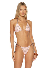 Front view of pink polka dot bikini bottoms with ruched front and brown tie sides