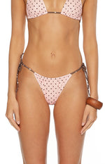 Front view of pink polka dot tie side bikini bottoms with brown strings adjustable for a perfect fit