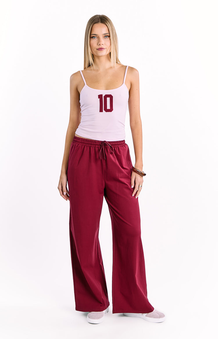 Burgundy wide leg pants with an elasticated drawstring waist and relaxed fit