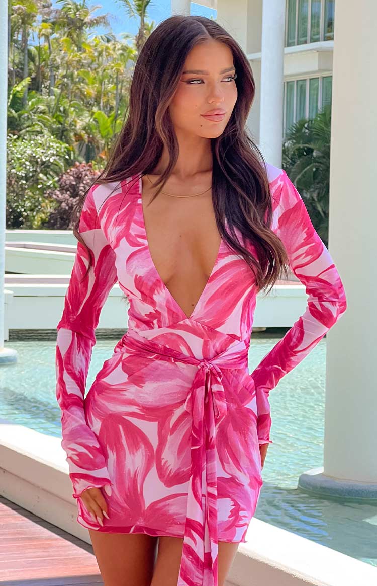 Deep V-neckline and wrap tie waist of a pink floral long sleeve mini dress