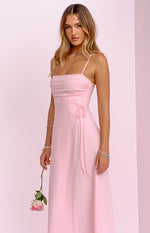 Side view of a pink maxi dress showing the ruched side detail with adjustable ties, square neckline and thin straps