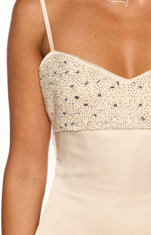 Close-up of the cream sequin and bead embellished sweetheart neckline of a mini dress