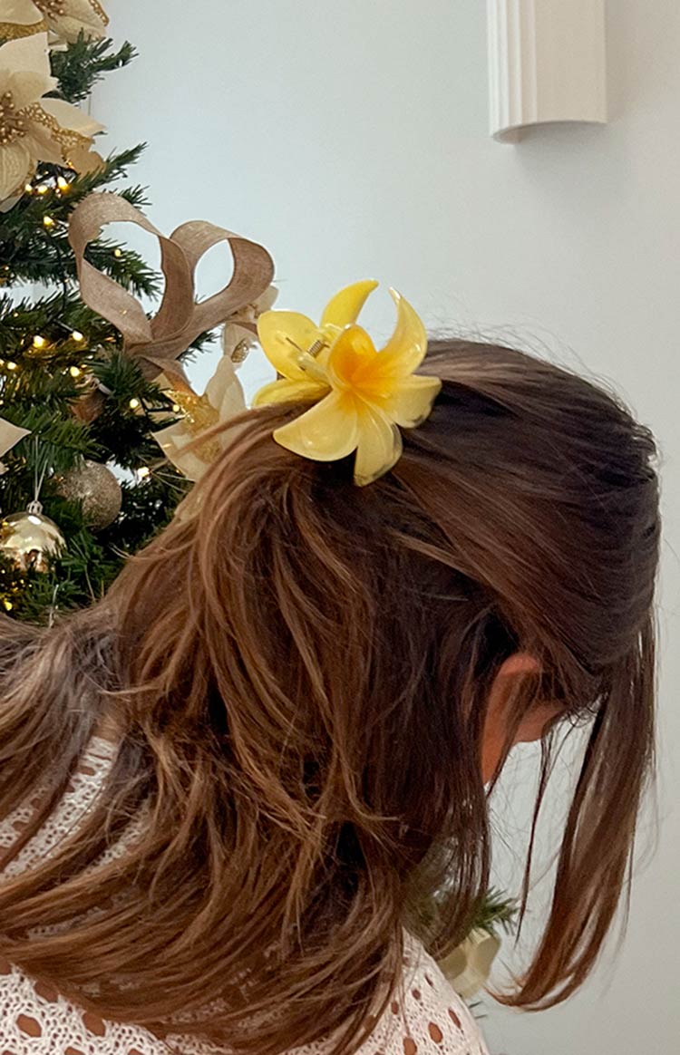 Yellow translucent frangipani flower clip showing its claw mechanism