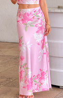Full length view of the pink floral maxi skirt, showing its high waist and flowing silhouette with white and green blooms