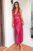 Side view of the pink satin maxi skirt, highlighting its smooth, flowing fabric and long, elegant drape