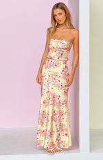 Yellow floral print maxi skirt with a flowy fit and vibrant pink and orange blooms