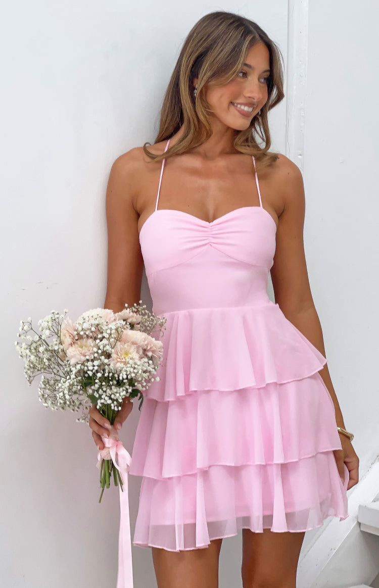 Pink mini dress with a ruched sweetheart bust and three-tiered sheer ruffle skirt