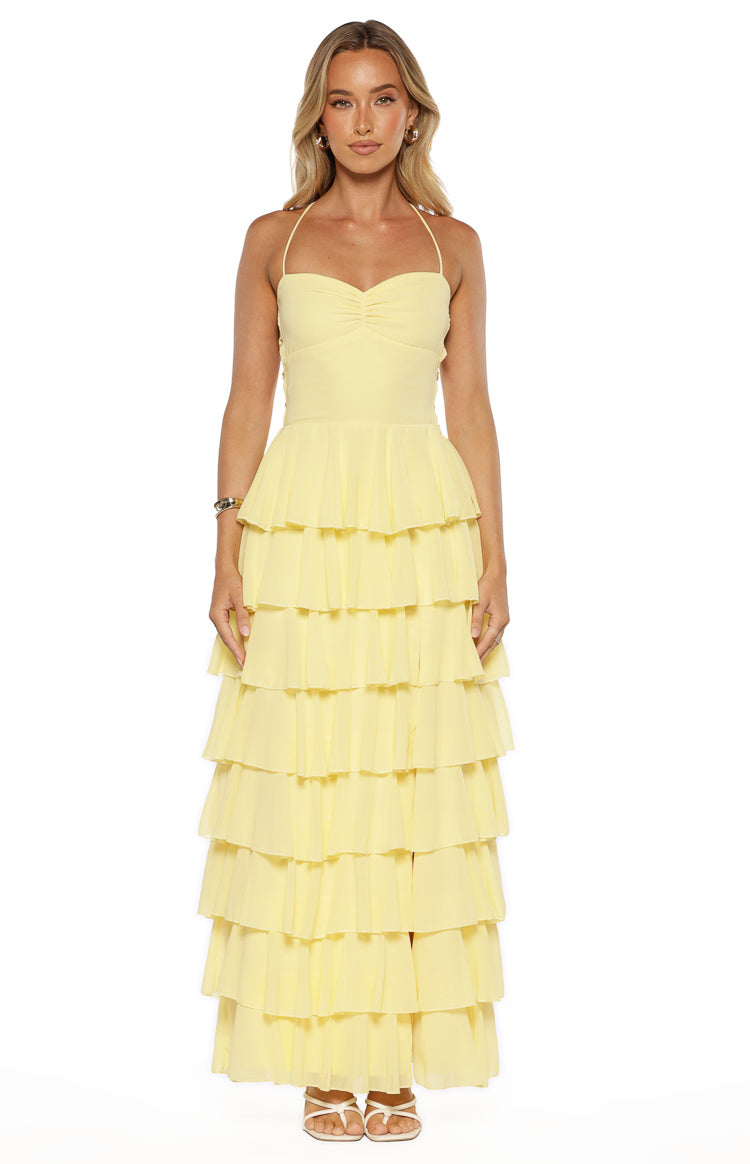 Front view of the yellow maxi dress with a ruched halter neckline and tiered ruffle skirt
