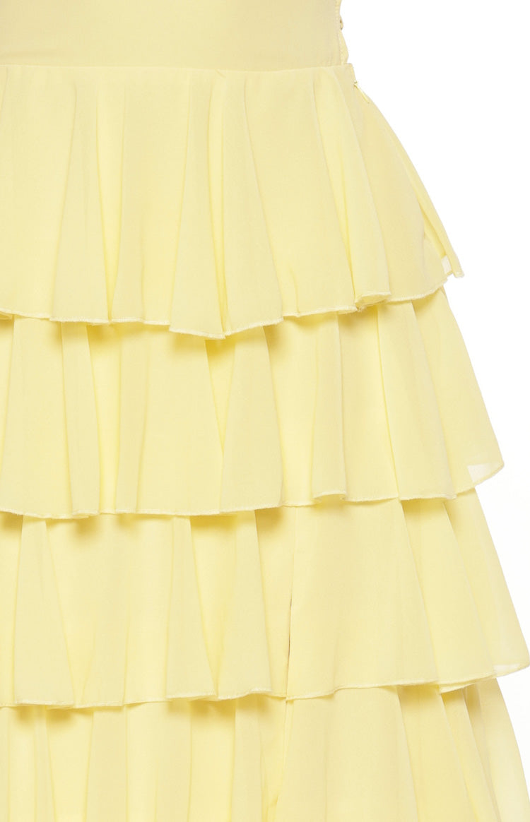 Close-up of the tiered ruffles on the skirt of the yellow maxi dress