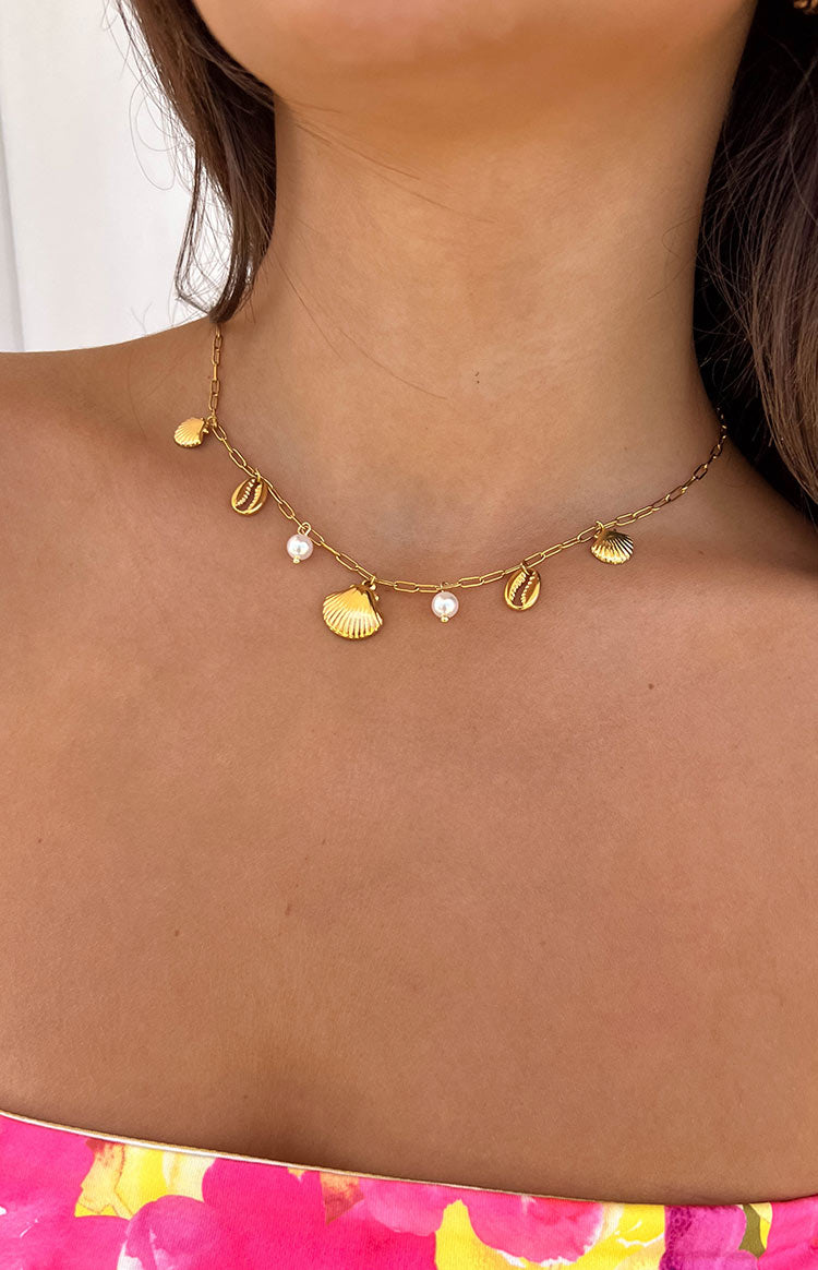 Beginning Boutique Gigli Gold Shell Necklace gold chain necklace with various shell charms and small white pearl accents