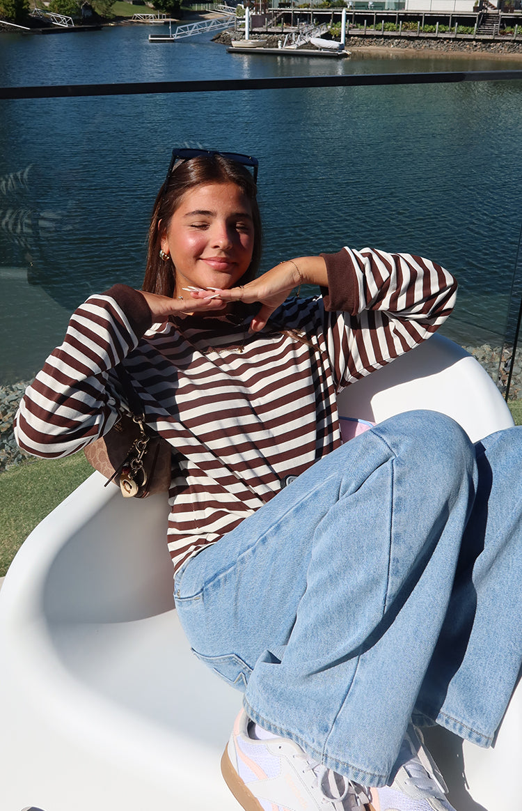 Chocolate and white stripe long sleeve top with a high neckline and ribbed brown cuffs