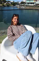 Chocolate and white horizontal stripe long sleeve top with a crew neck and relaxed fit