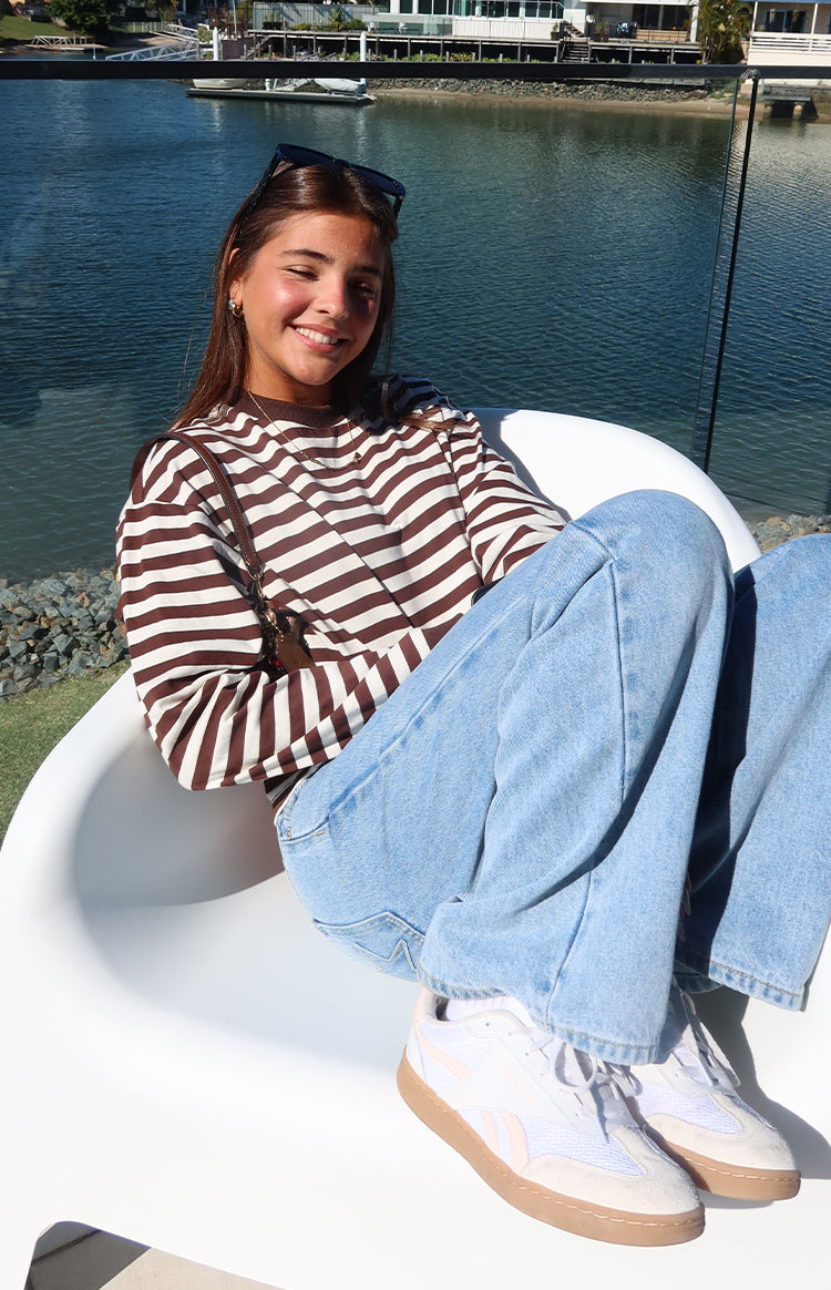 Relaxed fit chocolate and white stripe long sleeve top with a crew neck and dropped shoulders
