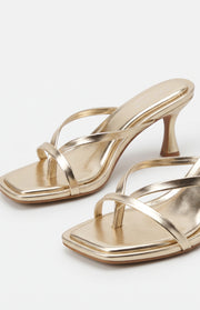 Metallic gold kitten heels with thin multi-straps, a square toe, toe-post detail, and flared kitten heel