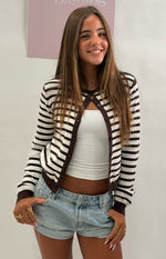 Front view of a chocolate and white stripe round neck cardigan, partially unbuttoned, with dark brown buttons