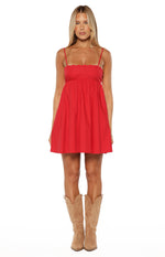 Front view of a red babydoll mini dress with thin spaghetti straps and a scalloped embroidered neckline
