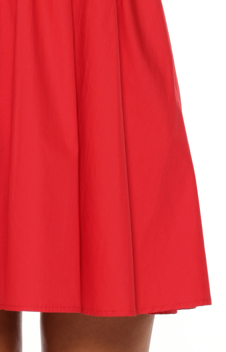 Close-up of the red mini dress hemline and the gathered skirt fabric