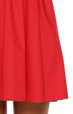Close-up of the red mini dress hemline and the gathered skirt fabric