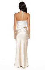 Back view of the white halter top with tie neck and wrap detail, showing the cutout waist and champagne satin maxi skirt