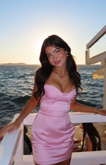 Light pink satin mini dress with a sweetheart neckline, delicate lace trim, and bustier-style bodice