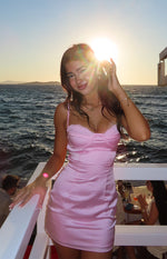 Light pink satin mini dress with a bustier bodice and delicate lace trim on the cups