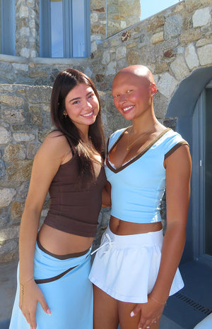 Brown scoop neck tank top with thin spaghetti straps and a fitted cropped silhouette