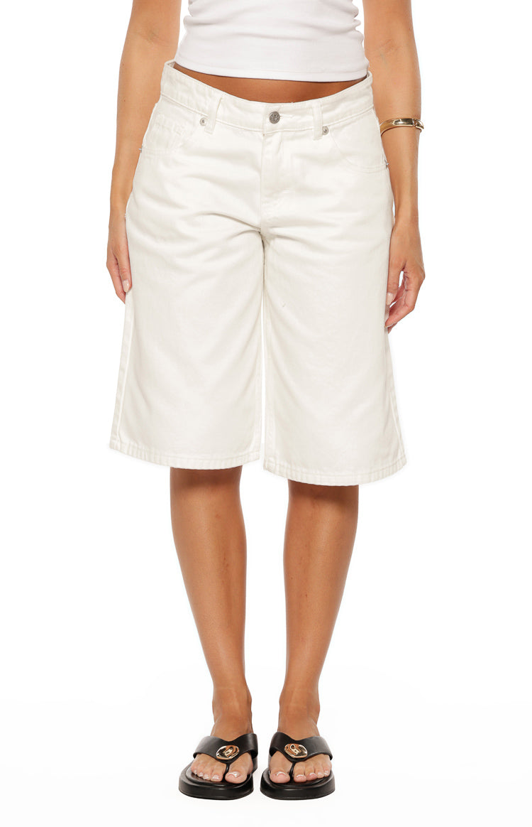 Front view of white wide-leg denim shorts featuring a button-front closure, belt loops, and front pockets, cut to above the knee