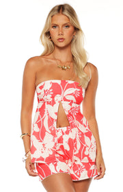 Front view of a red and white floral strapless longline top with a split front detail