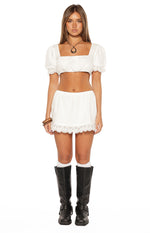 Front view of a white broderie trim crop top featuring a square neckline and short puff sleeves