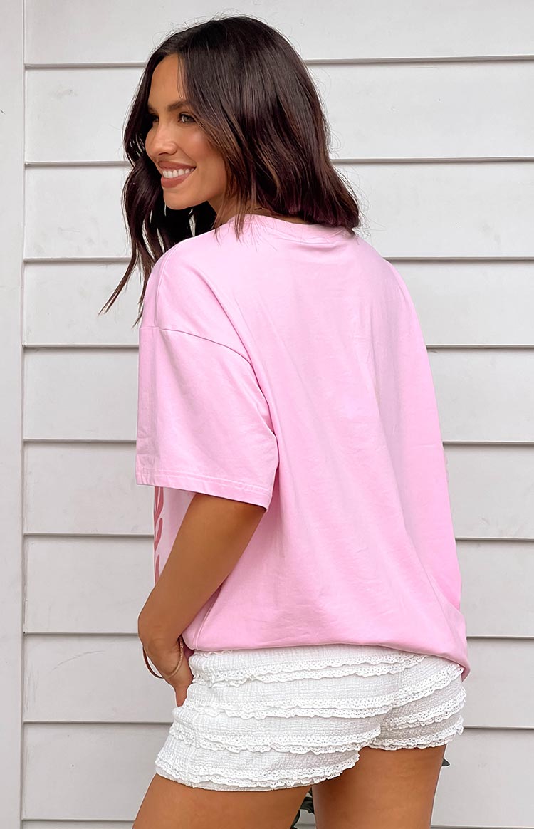 Side view of a plain pink oversized jersey tee with dropped shoulders and short sleeves