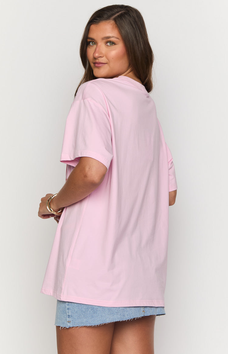 Rear-side view of a pink oversized tee with short sleeves and a plain back