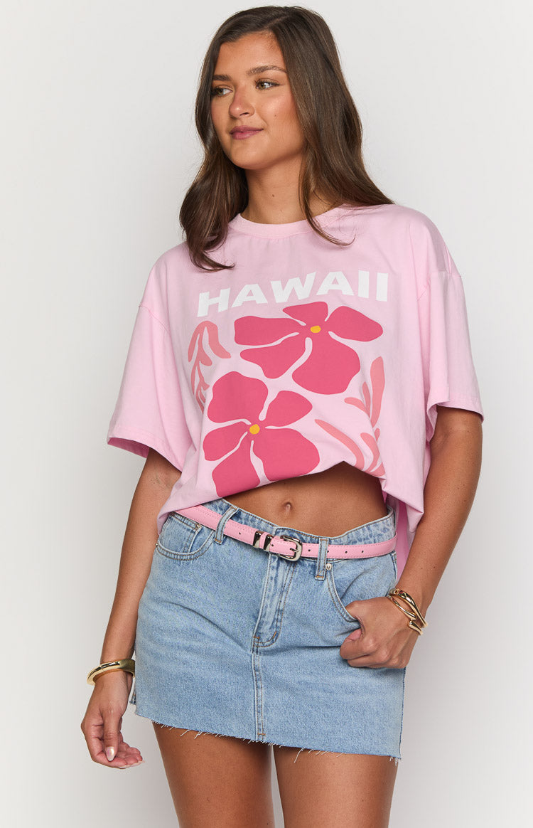 Close-up of the pink tee showing the 'HAWAII' text and large pink floral graphic, with a cropped hem