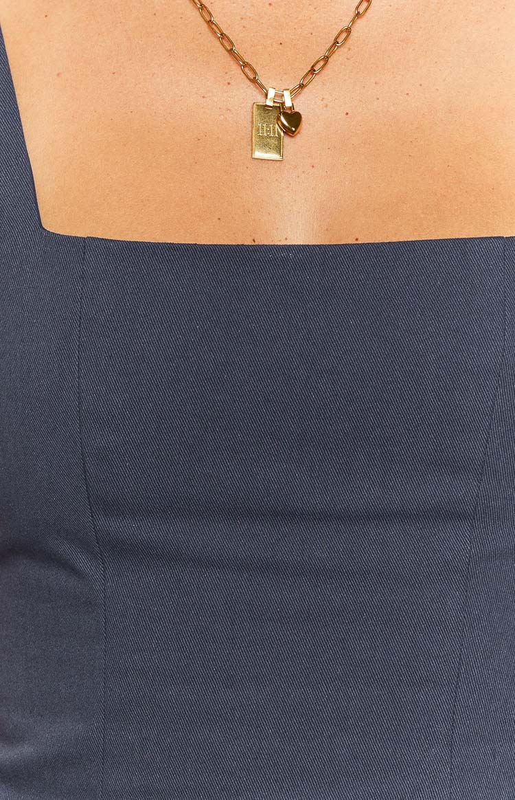 Close-up of the navy crop top's square neckline and diagonal weave fabric