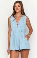 model wearing a flowy light blue playsuit with front tie detail