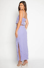 Side view of a purple crinkled maxi skirt with a high side split